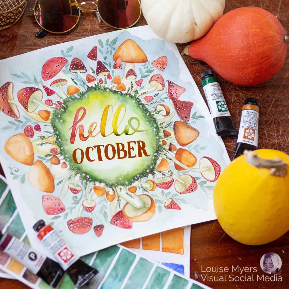 arte acuarela de hongos que rodean las palabras "hola octubre" con pinturas y calabazas en la mesa de madera.